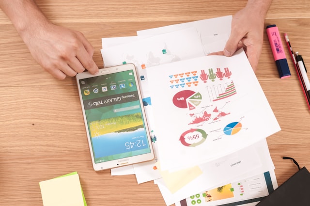 A person working with demographic data and a tablet. 