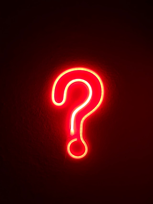 A question mark neon red light. 