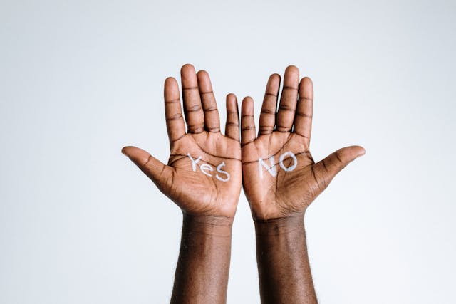 The words “yes” and “no” written on palms on a white background. 