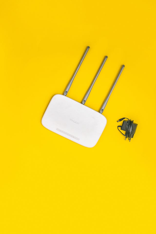 A router with a yellow background. 