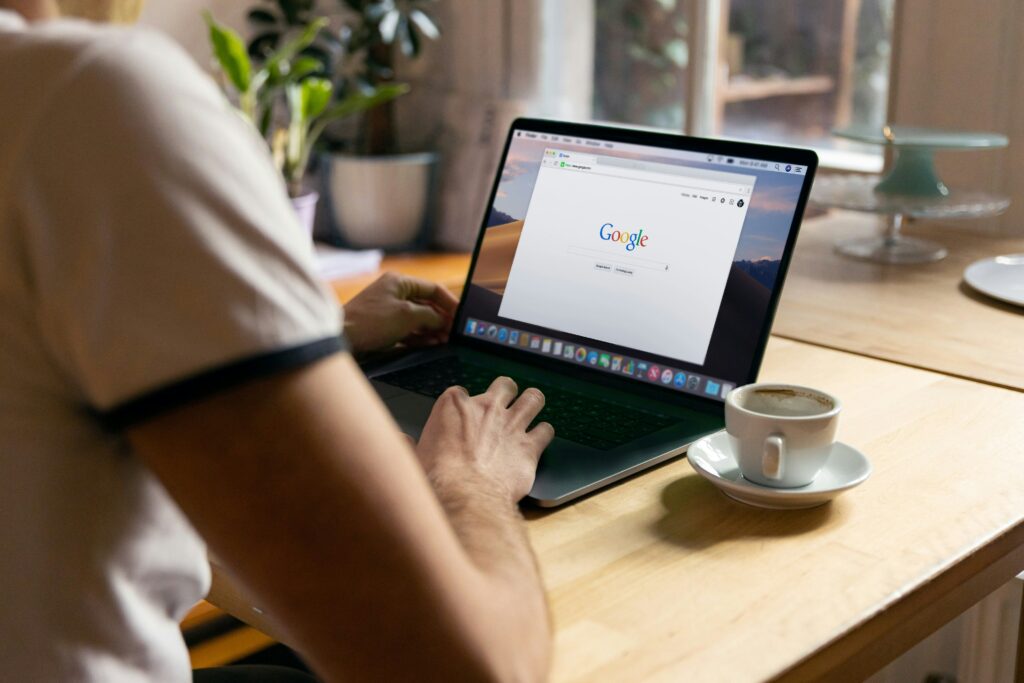 Image showing a man using a browser on his laptop.