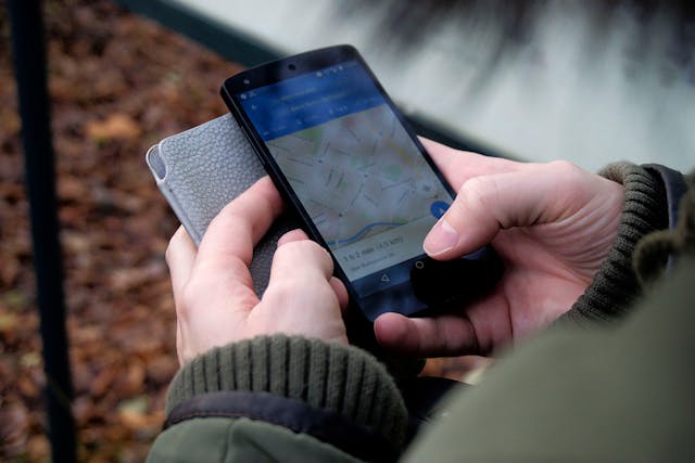 image showing a man using Google Maps on his phone.