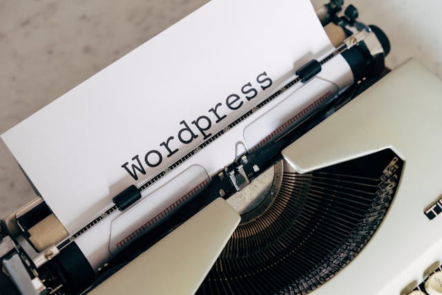 The word “WordPress” on a piece of paper in a typewriter. 